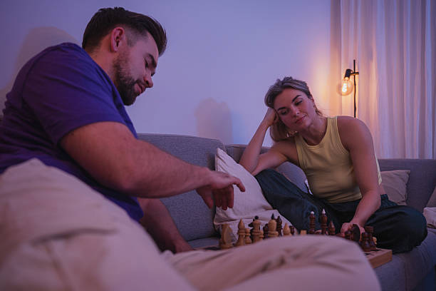 istock Couple Playing Chess Together on Sofa During Cozy Evening at Home 2226482752