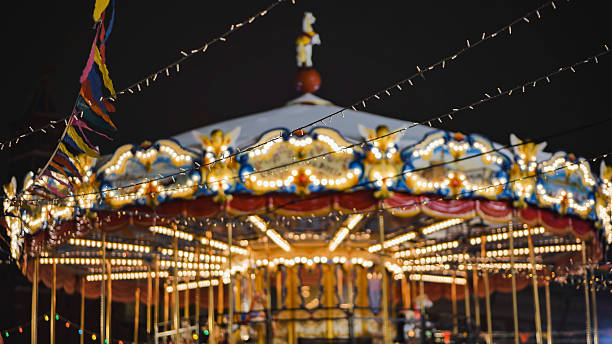 istock Colorful carousel with lights shining at night in amusement park 2226484461