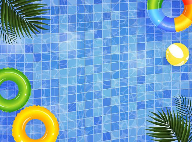 istock Colorful inflatable rings and beach ball floating in swimming pool with palm tree leaves 2226485483