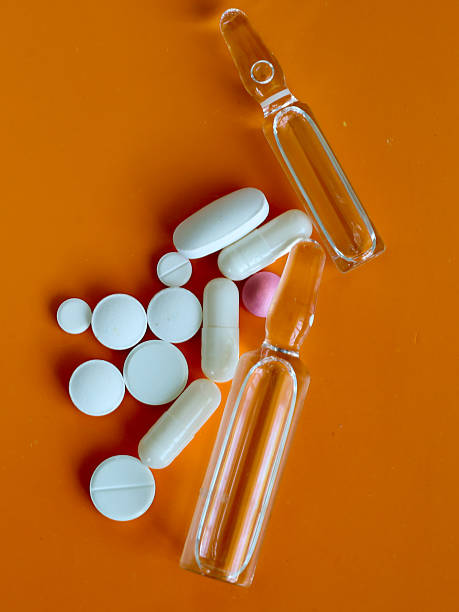 istock A composition of medical ampoules and various pills on a bright background creates an image of modern pharmaceutics. This visual series highlights the global significance of medicine, treatment, and health support. 2226486543