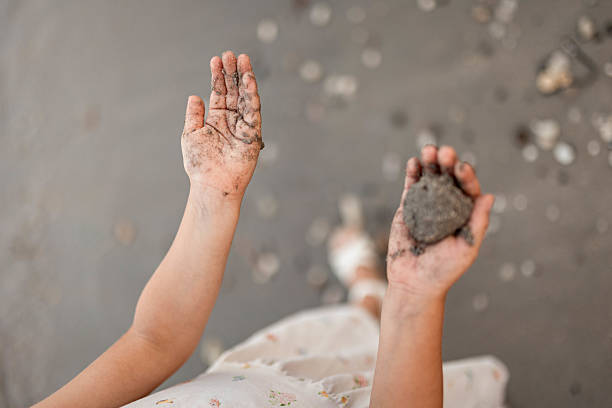 Close-up photo of little girl's hands with sand in them.