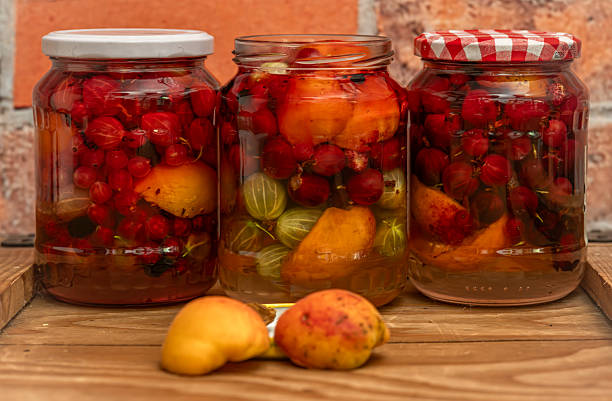 Fruit mix compote on wooden box near red brick old wall