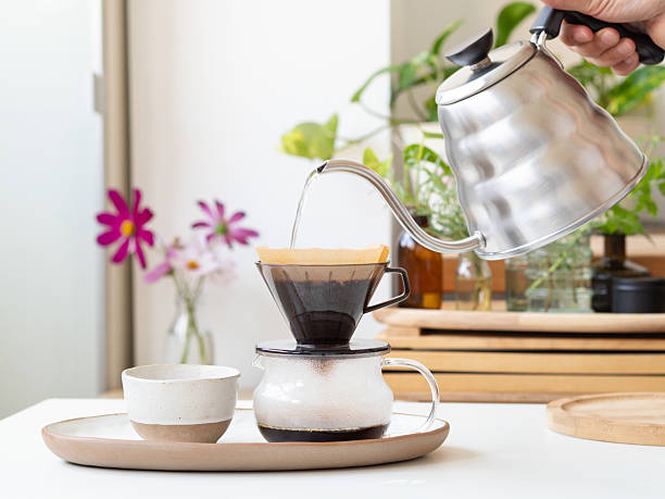 istock Barista pouring hot water into coffee dripper 2226489830