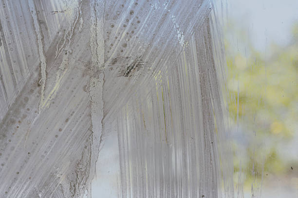 Dirty and dusty scratches paint on glass window background.