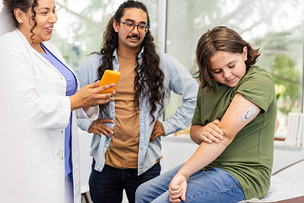 istock Doctor using a portable information device with patient and parent 2226493750