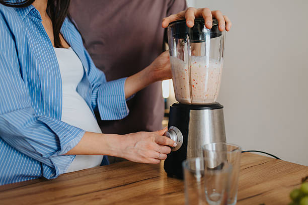 istock Happy couple preparing healthy fruit smoothie at home 2226495090
