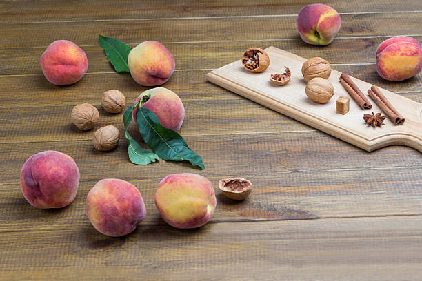Fresh organic peaches  hanging on a tree branch in a fresh and bountiful orchard, surrounded by green leaves and the vibrant colors of nature