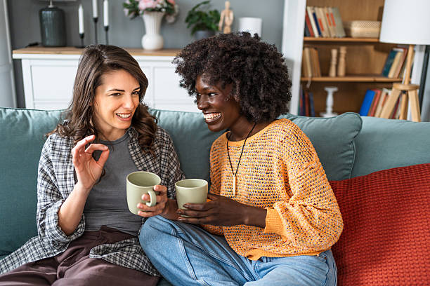 istock Two female friends enjoying a relaxing chat on sofa with coffee 2226498190