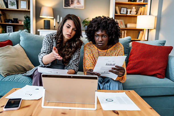 istock Two young women having financial problems at home 2226498454