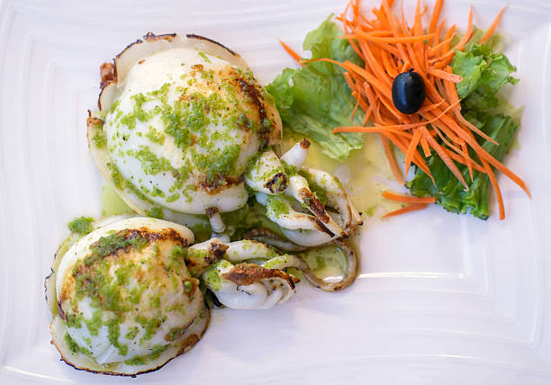 istock A dish with a grilled cuttlefish served with salad on a white plate. 2226499273
