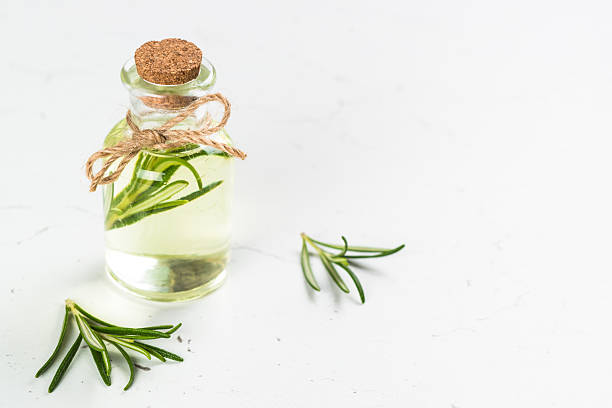 istock Rosemary essential oil in the bottle on white. 2226500969