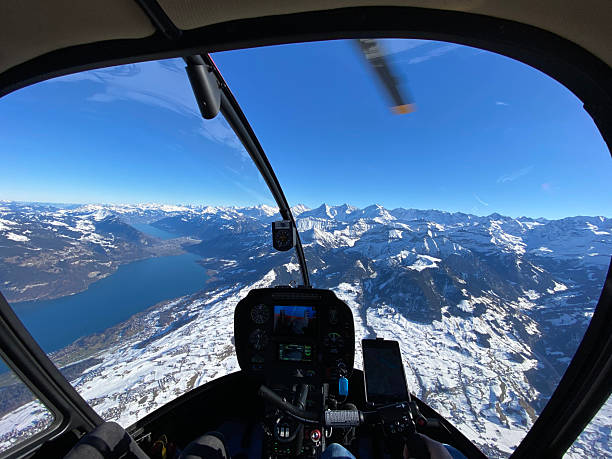 istock Alpine helicopter flies over mountains 2226501792