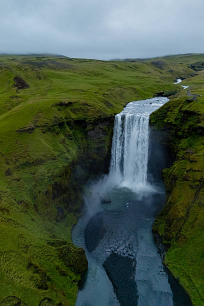 istock Majestic Skogafoss waterfall cascading down green cliffs in Iceland on a cloudy day 2226502045