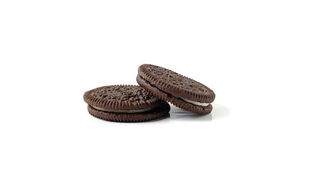Stacked Chocolate Sandwich Cookies on White Background