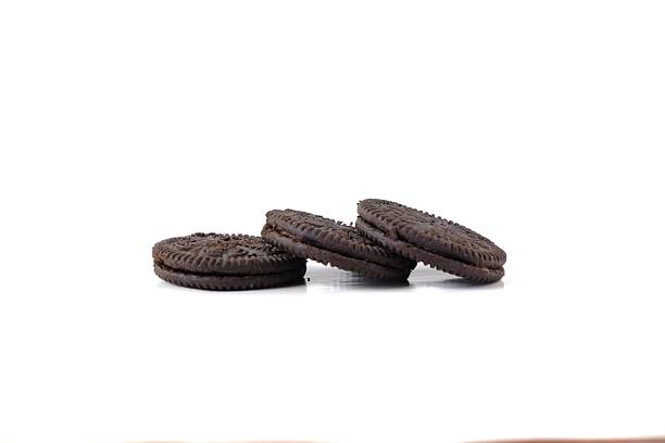 Stacked Chocolate Sandwich Cookies on White Background