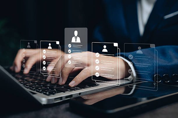 istock Digital recruitment process concept. Businessman typing on laptop with virtual resumes for candidate selection and hiring. 2226504211