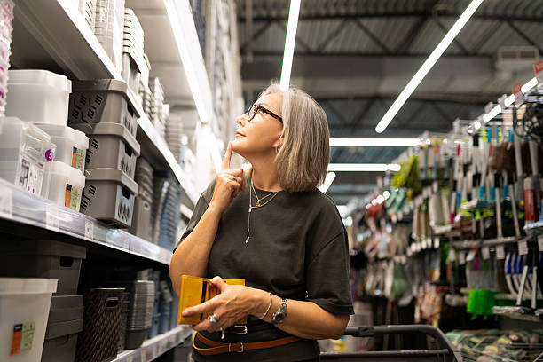 istock Middle-aged woman shopping for home essentials in a modern construction hypermarket exploring various departments 2226505746