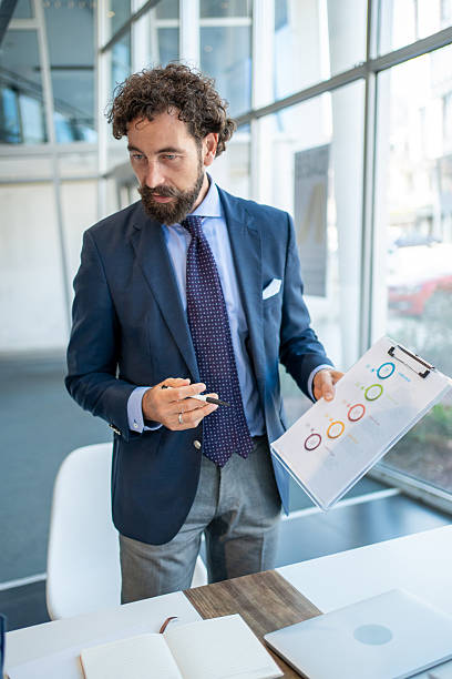 istock Businessman presenting charts and graphs in a modern office 2226506895