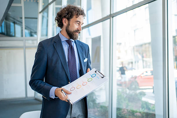 istock Businessman analyzing charts and graphs in modern office 2226506900