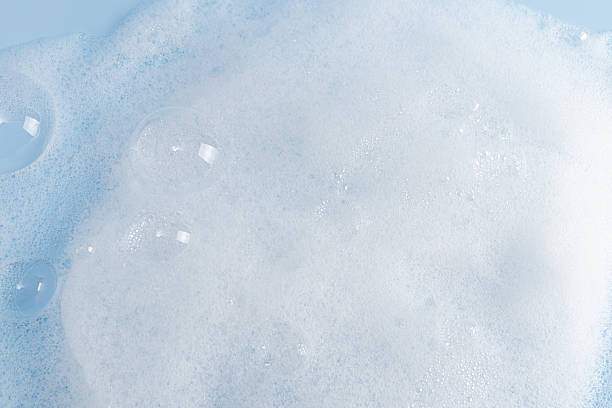 istock Chic white fluffy foam, soap foam texture with clear bubbles on blue background. A copy space. Layout for advertising detergent, spa cosmetics. 2226507734