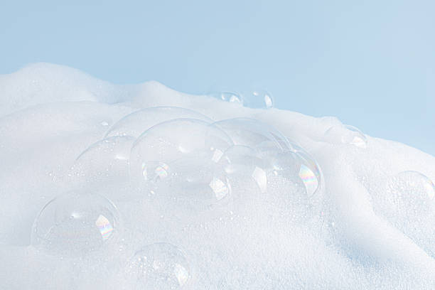 istock Chic white fluffy foam, soap foam texture with clear bubbles on blue background. A copy space. Layout for advertising detergent, spa cosmetics. 2226507741