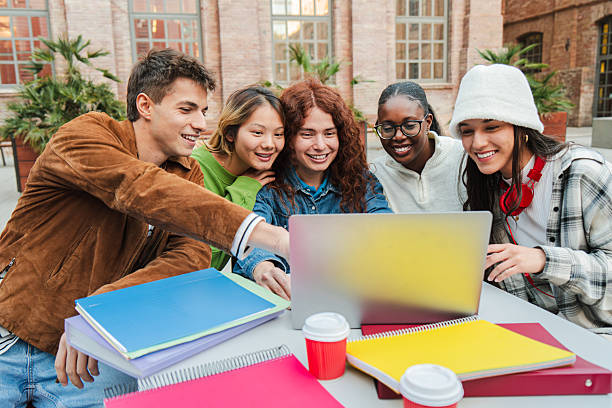 istock Enthusiastic group of students collaborating on a laptop while sharing ideas and enjoying their time 2226513187