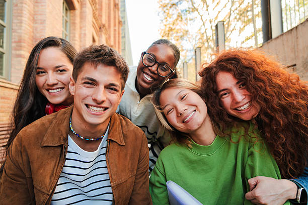 istock Joyful group of diverse young friends posing together for a fun portrait while sharing laughter and capturing memories during their university experience in a casual moment of friendship 2226514283