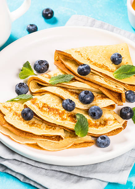 istock Crepes with blueberries at blue table. 2226515452