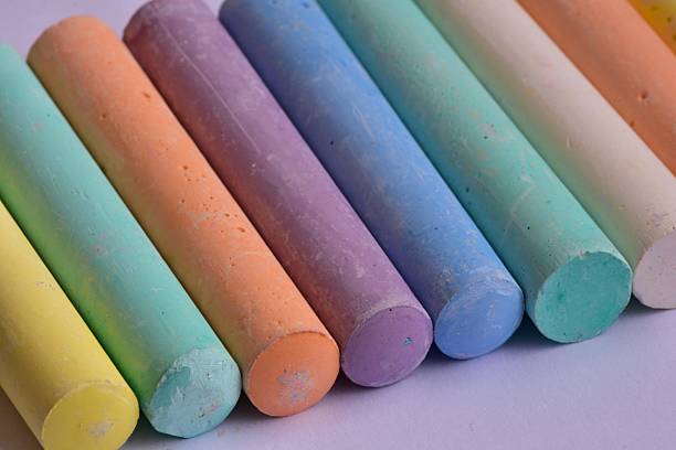 istock Side angle view of large pastel chalk sticks arranged in neat rows. Artistic texture and vibrant colors represent creative expression, school supplies, and children drawing tools. 2226516557