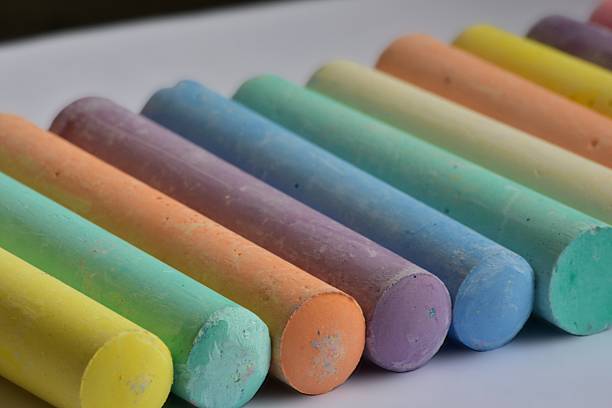 istock Side angle view of large pastel chalk sticks arranged in neat rows. Artistic texture and vibrant colors represent creative expression, school supplies, and children drawing tools. 2226516558