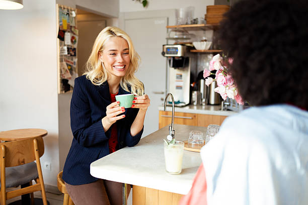istock Two young women talking and drinking coffee in a cafe 2226517164