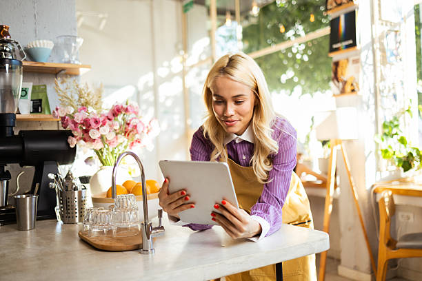 istock Coffee shop owner using digital tablet and managing business 2226517288