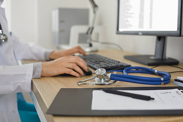 istock Doctor working at computer and typing electronic medical record sitting near stethoscope. 2226518034