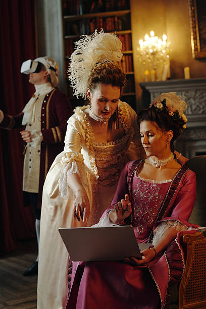 istock Two Caucasian Middle Aged Women Using Laptop in Baroque Renaissance Setting 2226521200