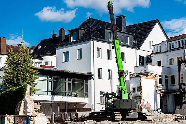 istock Construction work with a green crane in urban area with debris 2226521252