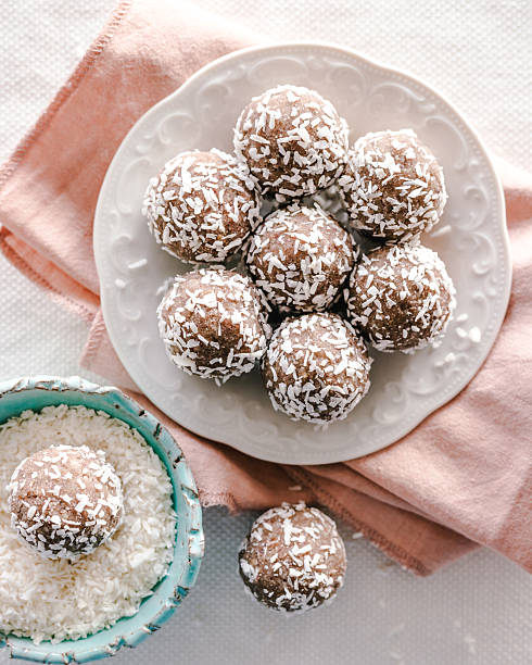 Overhead view of homemade date snack energy balls rolled in shredded coconut