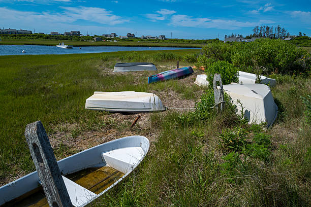 Views of one of the many inlets in the village of Madaket on Nantucket Island, MA off the coast of Cape Cod.    Madaket is located on the western end of the Island of Nantucket and has a population of about 240 people.  Madaket was home to Mildred Carpenter Jewett, a Nantucket native commonly referred to as Madaket Millie.  Born in 1907, Millie served as a Coastal Defense Specialist during World War II patrolling the shores for German submarines.