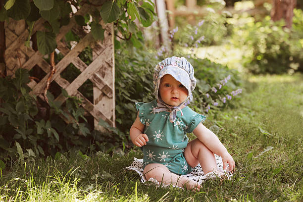 An adorable baby girl, seven months old, wearing a bonnet. Shot with a Canon 5D Mark IV.