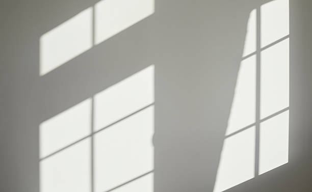 istock Empty grey interior wall background with light and shadows from the house windows 2226526453