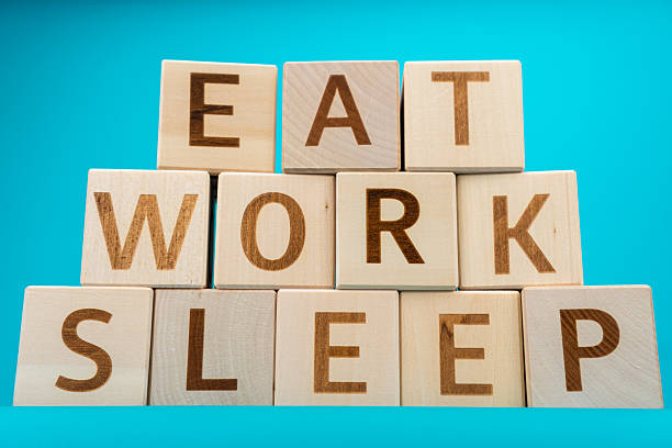 istock Wooden letter cubes with words eat work sleep 2226527149
