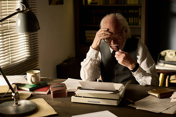 istock Senior Caucasian Man Concentrating While Reading Document at Desk Indoors 2226534279