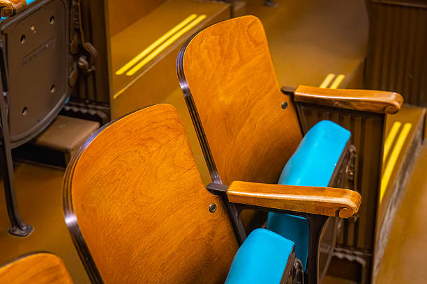 Two vintage red movie theater chairs isolated on a white background