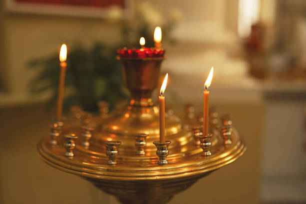 istock lit candles in church 2226535579