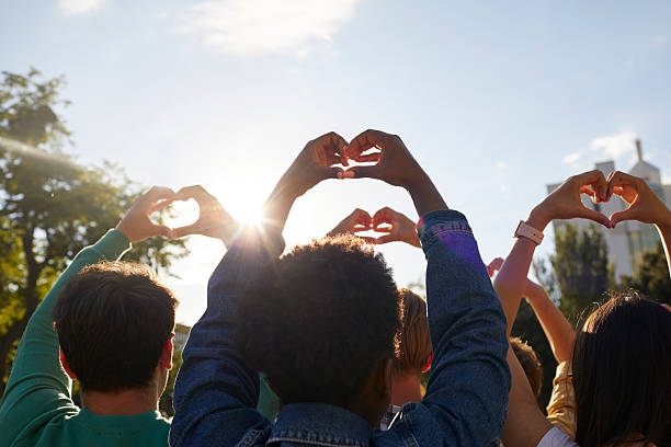 istock Group friends doing heart symbol shape with both hands against sunset 2226535925