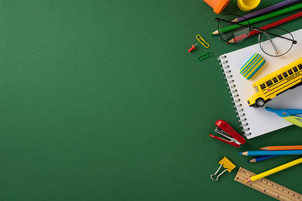 istock Various school supplies including a notebook, pencils, and bus toy placed on green background, leaving space for copy 2226536818