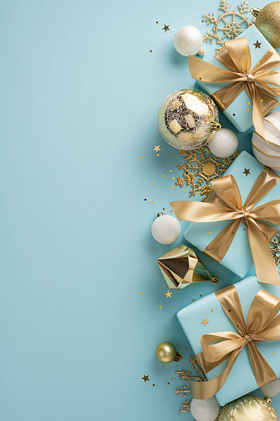 istock Golden and teal vertical gift boxes adorned with bows, surrounded by festive ornaments and decorations 2226536838