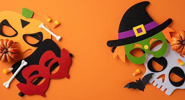 istock Halloween decorations featuring playful masks and themed items arranged on an orange backdrop 2226536845