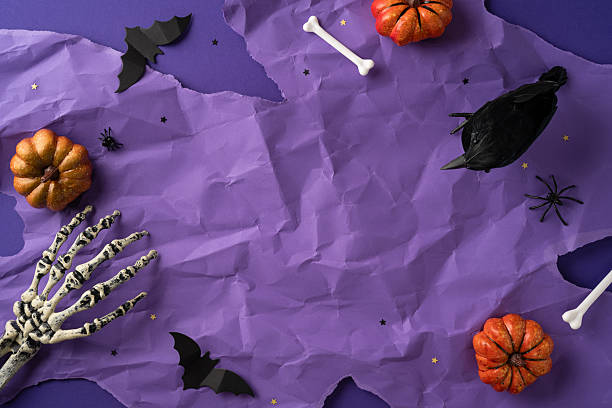 istock Creepy Halloween background featuring pumpkins, a skeleton hand, a bat, and festive decorations creating a spooky atmosphere 2226536846