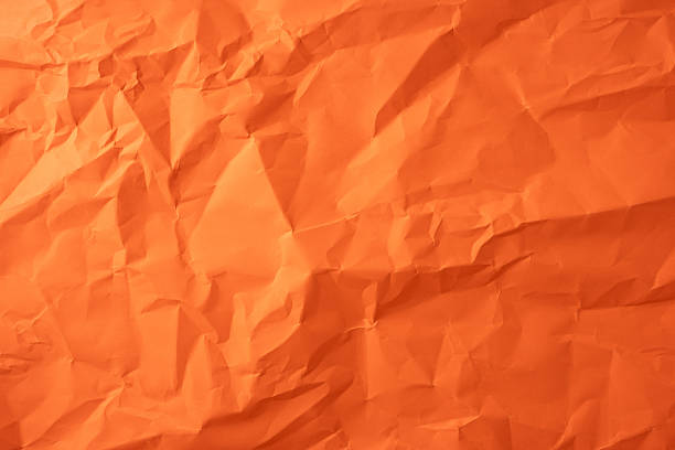 istock Crumpled vibrant orange paper surface offering a unique design texture and creative background 2226536864