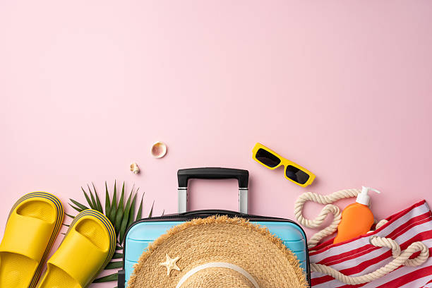 istock Flat lay travel elements including a suitcase, sunglasses, hat, and sunscreen on a colorful surface, ideal for summer vacation concepts 2226536892